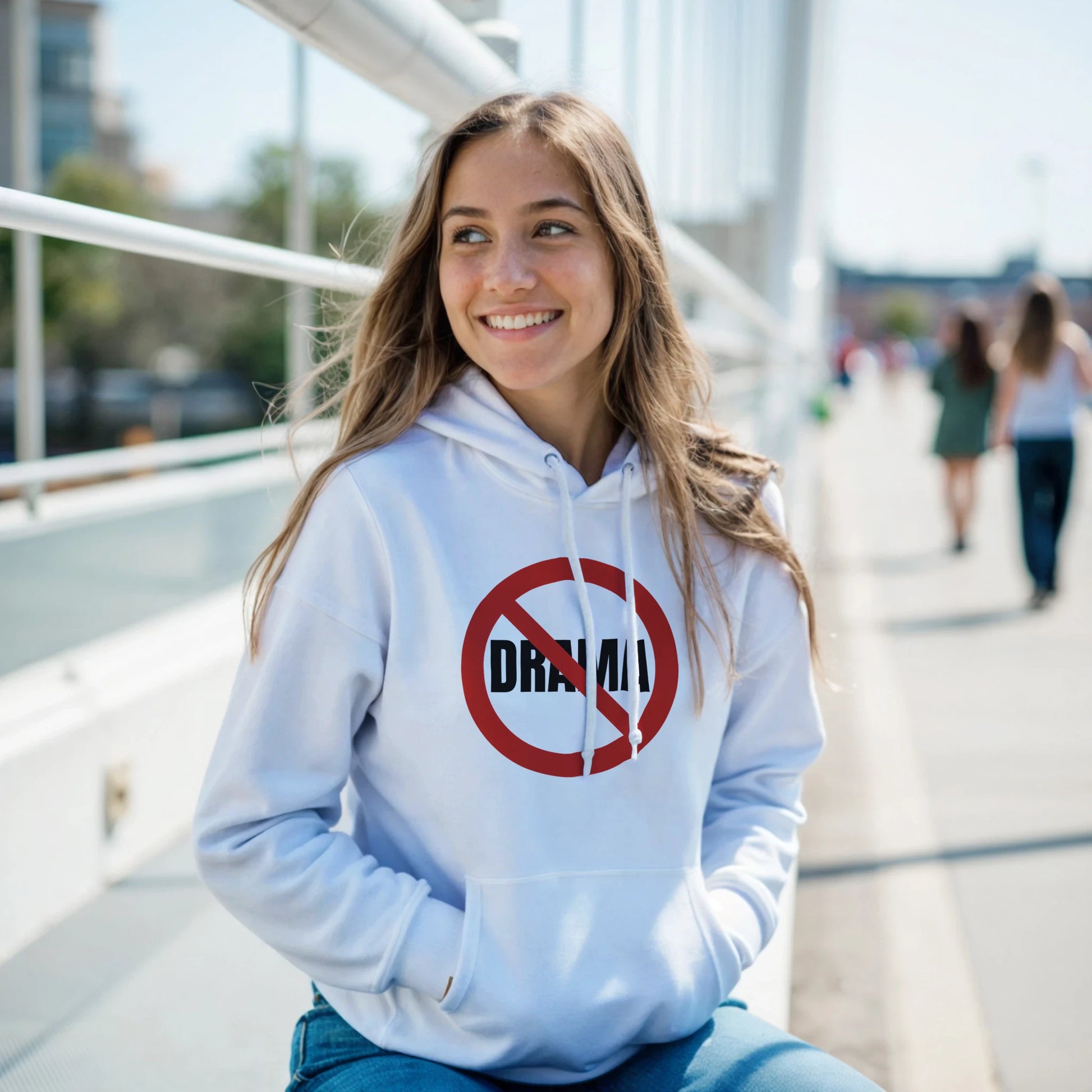 Woman wearing a white hoodie with a red and black NO DRAMA graphic